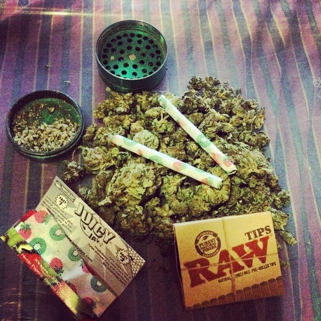 Rolling papers, grinder, and marijuana